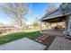 Large backyard with a patio, green lawn, and mature trees, offering ample outdoor space at 6323 W 85Th Ave, Arvada, CO 80003