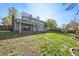 Well-maintained backyard with a covered patio, spacious lawn, and established landscaping at 6323 W 85Th Ave, Arvada, CO 80003