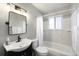 Full bathroom featuring tile flooring, a combined tub and shower, and ample natural light at 6323 W 85Th Ave, Arvada, CO 80003