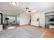 Bright bedroom with light wood floors, large rug, ceiling fan, and access to a comfortable sitting area at 6323 W 85Th Ave, Arvada, CO 80003
