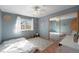 Charming bedroom featuring natural light, a ceiling fan, and a large mirrored closet at 6323 W 85Th Ave, Arvada, CO 80003