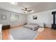 Spacious bedroom with a wood-burning stove and ample natural light from a large window at 6323 W 85Th Ave, Arvada, CO 80003