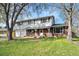 Charming two-story home with a brick and siding facade, two-car garage, and a covered front porch at 6323 W 85Th Ave, Arvada, CO 80003