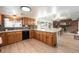 Well-lit kitchen featuring abundant counter space and cabinetry with a seamless view to dining room at 6323 W 85Th Ave, Arvada, CO 80003