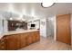 Open kitchen with ample cabinetry, long island counter, and access to the dining and living area at 6323 W 85Th Ave, Arvada, CO 80003
