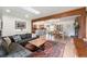 Bright, open-concept living area with hardwood floors, fireplace, and seamless flow to the dining and kitchen spaces at 6323 W 85Th Ave, Arvada, CO 80003