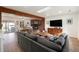Inviting living room with hardwood floors, brick fireplace, and a skylight offering natural light at 6323 W 85Th Ave, Arvada, CO 80003