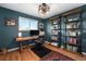 Home office with custom shelving, a comfortable desk, and a stylish ceiling fan at 6323 W 85Th Ave, Arvada, CO 80003