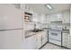 Bright kitchen featuring white appliances, granite countertops, and ample cabinet space at 9995 E Harvard Ave # 246, Denver, CO 80231