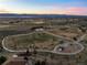 Scenic aerial shot of the neighborhood featuring a community park and distant mountain views at 2577 Shadecrest Pl, Highlands Ranch, CO 80126