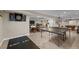 Spacious basement includes ping pong table, bar and lounge area for entertaining at 2577 Shadecrest Pl, Highlands Ranch, CO 80126
