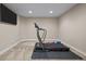 Finished basement with TV and exercise equipment at 2577 Shadecrest Pl, Highlands Ranch, CO 80126