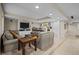 Basement living area has a TV, sofas, bar with seating and wine racks at 2577 Shadecrest Pl, Highlands Ranch, CO 80126