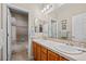 Bright bathroom with double sinks and tile backsplash at 2577 Shadecrest Pl, Highlands Ranch, CO 80126