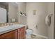 Powder room featuring a vanity with decorative tiling, a toilet, and modern decor at 2577 Shadecrest Pl, Highlands Ranch, CO 80126