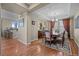 Inviting dining room with hardwood floors, elegant lighting, and neutral wall color at 2577 Shadecrest Pl, Highlands Ranch, CO 80126