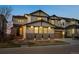 Charming two-story home with stone accents, a well-manicured lawn, and a welcoming entrance at 2577 Shadecrest Pl, Highlands Ranch, CO 80126