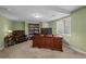 Home office features a large wooden desk, bookshelves, and comfortable seating at 2577 Shadecrest Pl, Highlands Ranch, CO 80126
