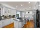 Bright, spacious kitchen featuring granite counters, stainless appliances, and a breakfast bar at 2577 Shadecrest Pl, Highlands Ranch, CO 80126