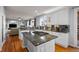 Bright kitchen featuring granite countertops, stainless appliances, central island, and hardwood flooring at 2577 Shadecrest Pl, Highlands Ranch, CO 80126