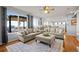 Open living area with plush sofas, a patterned rug, large windows offering mountain views, and hardwood flooring at 2577 Shadecrest Pl, Highlands Ranch, CO 80126