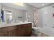 Bright bathroom featuring a double vanity with dark wood cabinets and a shower/tub combination at 21650 E Tufts Cir, Aurora, CO 80015