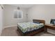 Cozy bedroom showcasing a comfortable bed, soft carpet, and a bright window at 21650 E Tufts Cir, Aurora, CO 80015