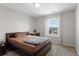 Cozy bedroom with a neutral color scheme and a window providing natural light at 21650 E Tufts Cir, Aurora, CO 80015