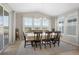 Elegant dining room with large windows, offering scenic views and abundant natural light at 21650 E Tufts Cir, Aurora, CO 80015