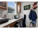 Bright home office featuring custom cabinets, sleek countertops, modern decor and a comfortable ergonomic chair at 21650 E Tufts Cir, Aurora, CO 80015