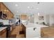 Open-concept kitchen featuring stainless steel appliances, a large island, and stylish pendant lights at 21650 E Tufts Cir, Aurora, CO 80015