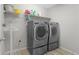 Efficient laundry room with washer, dryer, and shelving for storage at 21650 E Tufts Cir, Aurora, CO 80015
