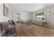 Cozy living room filled with natural light featuring wood floors and stylish neutral furniture at 21650 E Tufts Cir, Aurora, CO 80015