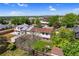 Aerial view captures the home with a wooden fence, patio, and mature trees surrounding a backyard at 1982 S Truckee St, Aurora, CO 80013
