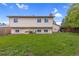 Wide backyard with a large grass area and exterior view of the two-story home at 1982 S Truckee St, Aurora, CO 80013