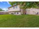 Home backyard featuring a well-maintained lawn and a brick chimney and patio at 1982 S Truckee St, Aurora, CO 80013