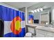 Bathroom featuring a single sink vanity and a shower with a Colorado flag shower curtain at 1982 S Truckee St, Aurora, CO 80013