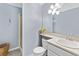 Bathroom featuring blue walls, a single sink vanity, a shower, and decor sunflowers at 1982 S Truckee St, Aurora, CO 80013