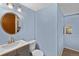 Small bathroom with blue walls, a round mirror, and vanity at 1982 S Truckee St, Aurora, CO 80013