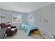 Bedroom with a chair, a single bed, carpet, and themed wall art at 1982 S Truckee St, Aurora, CO 80013