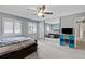 Bedroom featuring a ceiling fan, carpeted floors, a mirrored closet, and natural light at 1982 S Truckee St, Aurora, CO 80013