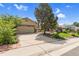 Charming home featuring a large driveway leading to an attached garage and landscaped front yard at 1982 S Truckee St, Aurora, CO 80013