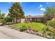 Lovely home with green lawn, mature trees, and tasteful landscaping at 1982 S Truckee St, Aurora, CO 80013