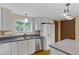 Well-lit kitchen with white cabinets, stainless steel appliances, and blue countertop at 1982 S Truckee St, Aurora, CO 80013