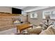 Cozy living room with brick fireplace, wood mantel, and comfortable seating at 1982 S Truckee St, Aurora, CO 80013