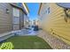 Modern backyard with artificial turf, concrete steps, and low-maintenance landscaping between homes at 21851 E Tallkid Ave, Parker, CO 80138