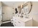 Elegant bathroom featuring double sinks, a walk-in shower, and modern lighting fixtures at 21851 E Tallkid Ave, Parker, CO 80138