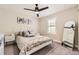 Cozy bedroom with a white metal bed frame, neutral decor, and plenty of natural light at 21851 E Tallkid Ave, Parker, CO 80138