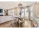Elegant dining area adjacent to living room with modern light fixture and outdoor access at 21851 E Tallkid Ave, Parker, CO 80138