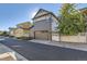 Two-story home featuring a two-car garage with carriage doors and neatly manicured landscaping at 21851 E Tallkid Ave, Parker, CO 80138
